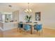 Elegant dining area with blue velvet chairs and chandelier at 415 L Ambiance Dr # C703, Longboat Key, FL 34228