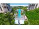 Resort-style pool area with lush landscaping and ocean views at 415 L Ambiance Dr # C703, Longboat Key, FL 34228