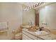 Clean bathroom with a vanity, toilet and marble countertops at 415 L Ambiance Dr # C703, Longboat Key, FL 34228