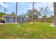 Spacious backyard with grassy lawn and a view of the house at 4403 Pike Ave, Sarasota, FL 34233