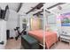 Spacious bedroom with a canopy bed, exercise bike, and large window at 4403 Pike Ave, Sarasota, FL 34233