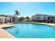 Community pool with palm trees and surrounding apartments at 4802 51St W St # 908, Bradenton, FL 34210