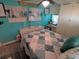 Bedroom with white dresser, ceiling fan, and coastal bedding at 5021 Pebble Beach Ave, Sarasota, FL 34234