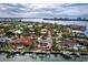 Aerial view of waterfront homes with private docks and lush landscaping at 526 N Spoonbill Dr, Sarasota, FL 34236