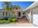 Inviting front entrance with brick pavers, stone accents, and lush landscaping at 5666 Beneva Woods Cir, Sarasota, FL 34233