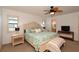 Main bedroom with king-size bed and ceiling fan at 7113 Fairway Bend Cir, Sarasota, FL 34243