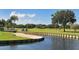 Golf course with water feature, sand trap, and golf cart at 7113 Fairway Bend Cir, Sarasota, FL 34243