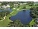 Aerial view of community landscape, golf course, and waterfront property at 7113 Fairway Bend Cir, Sarasota, FL 34243