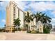 Luxury high-rise building with palm trees and fountain at 750 N Tamiami Trl # 912, Sarasota, FL 34236