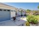 House entrance with gray garage door, paved walkway, and manicured landscaping at 806 Mcarthur Ave, Sarasota, FL 34243