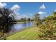 Beautiful pond view with lush greenery and blooming flowers at 806 Mcarthur Ave, Sarasota, FL 34243