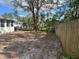 Large backyard with wooden fence and mature trees at 1936 E 30Th Ave, Bradenton, FL 34208