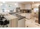 Modern kitchen with white cabinets, gray countertops, and breakfast bar at 203 Palm Air Dr, Osprey, FL 34229