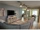 Spacious living room with a large sectional sofa and wall-mounted TV at 2271 50Th Street E Cir, Palmetto, FL 34221
