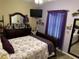 Cozy bedroom with decorative accents, a mounted TV, and a queen size bed at 2271 50Th Street E Cir, Palmetto, FL 34221
