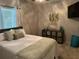 Neutral bedroom with mounted TV, decorations, and a queen-size bed at 2271 50Th Street E Cir, Palmetto, FL 34221