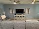 Living room featuring a sectional sofa, media console, and hardwood flooring at 2271 50Th Street E Cir, Palmetto, FL 34221