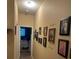 Charming hallway with custom Gathering photo gallery and view into a well-lit, cozy bedroom at 2271 50Th Street E Cir, Palmetto, FL 34221
