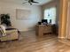 Bright home office features hardwood floors, large desk, and comfortable seating at 2271 50Th Street E Cir, Palmetto, FL 34221