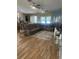 Open living room with sectional sofa, ceiling fans, and wood flooring at 2271 50Th Street E Cir, Palmetto, FL 34221