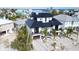 Modern two-story home with a black roof, nestled in a vibrant coastal community at 243 S Harbor Dr, Holmes Beach, FL 34217