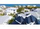 Aerial view of waterfront home showcasing unique architecture and private rooftop deck at 243 S Harbor Dr, Holmes Beach, FL 34217