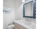 Charming bathroom with a unique scalloped mirror and a quartz countertop vanity at 243 S Harbor Dr, Holmes Beach, FL 34217