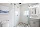 Modern bathroom with a large glass shower, stylish vanity, and neutral tile at 243 S Harbor Dr, Holmes Beach, FL 34217