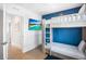 Well-lit bedroom with a built-in bunk bed, a large TV, and hardwood floors at 243 S Harbor Dr, Holmes Beach, FL 34217