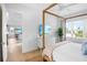 Spacious bedroom with a four poster bed and ensuite bathroom at 243 S Harbor Dr, Holmes Beach, FL 34217