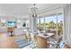 Bright dining room with a large table and access to a balcony overlooking the water at 243 S Harbor Dr, Holmes Beach, FL 34217