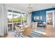 Coastal-styled dining room with sliding glass doors leading to a balcony at 243 S Harbor Dr, Holmes Beach, FL 34217