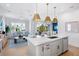 Open concept kitchen with a white quartz island and a view of the living room at 243 S Harbor Dr, Holmes Beach, FL 34217