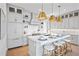 Modern kitchen featuring white cabinetry, white quartz countertops, and gold accents at 243 S Harbor Dr, Holmes Beach, FL 34217