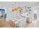 Modern kitchen with white cabinets, a large island, and gold pendant lights at 243 S Harbor Dr, Holmes Beach, FL 34217