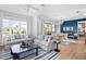 Spacious living area featuring a light gray sofa, striped rug, and large windows at 243 S Harbor Dr, Holmes Beach, FL 34217