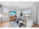 Bright living room with hardwood floors, comfy seating, and large windows at 243 S Harbor Dr, Holmes Beach, FL 34217