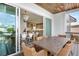 Outdoor patio with wicker furniture and view of the kitchen at 243 S Harbor Dr, Holmes Beach, FL 34217