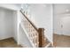 Clean and bright staircase with wooden handrail and tiled flooring at 243 S Harbor Dr, Holmes Beach, FL 34217