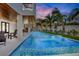 Long, rectangular pool with spa and outdoor seating area at 243 S Harbor Dr, Holmes Beach, FL 34217