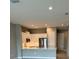 Modern kitchen featuring white cabinets, stainless steel appliances, and a breakfast bar at 24732 Buckingham Way, Port Charlotte, FL 33980