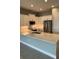 Modern kitchen with white cabinetry, stainless steel appliances, and an island at 24732 Buckingham Way, Port Charlotte, FL 33980