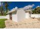 White guest house with a brown door and window at 2629 Rolling Rd, North Port, FL 34288