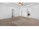 Main bedroom with carpeted floor, ceiling fan and walk-in closet at 3212 77Th E Ct, Palmetto, FL 34221