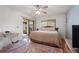 Relaxing bedroom with ceiling fan, light walls and access to an outdoor lanai at 3375 Sandleheath # 34, Sarasota, FL 34235