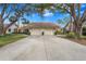 Front view of a two-car garage villa with landscaping at 3375 Sandleheath # 34, Sarasota, FL 34235