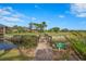 Picturesque golf course view with bridge, pond, and well-manicured green in a serene, members-only setting at 3375 Sandleheath # 34, Sarasota, FL 34235