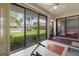 Outdoor lanai with ceiling fan offering a view of the pool and landscaped backyard at 3375 Sandleheath # 34, Sarasota, FL 34235