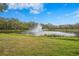 Beautiful pond featuring a fountain and lush green surroundings, creating a serene and inviting atmosphere at 3375 Sandleheath # 34, Sarasota, FL 34235