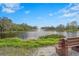 Scenic pond with a fountain surrounded by lush landscaping and a bench for relaxing and enjoying the view at 3375 Sandleheath # 34, Sarasota, FL 34235